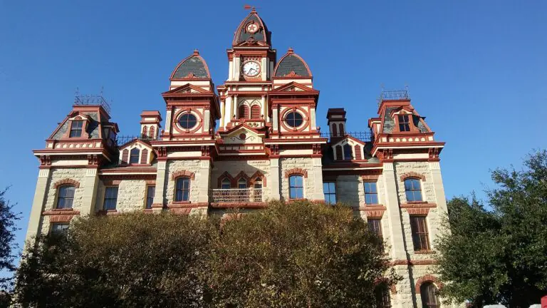 The Caldwell County Courthouse clock tower rising over trees in Lockhart